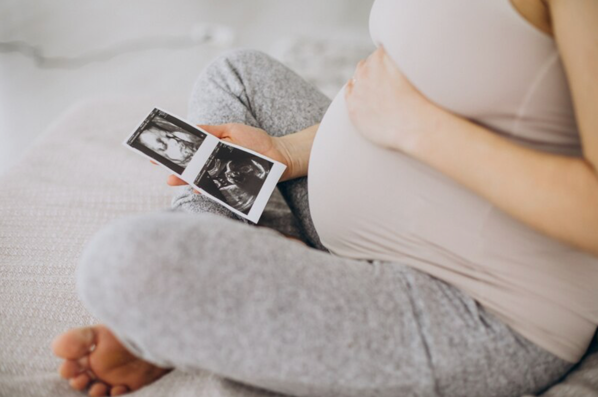 Pregnant woman looking at photos