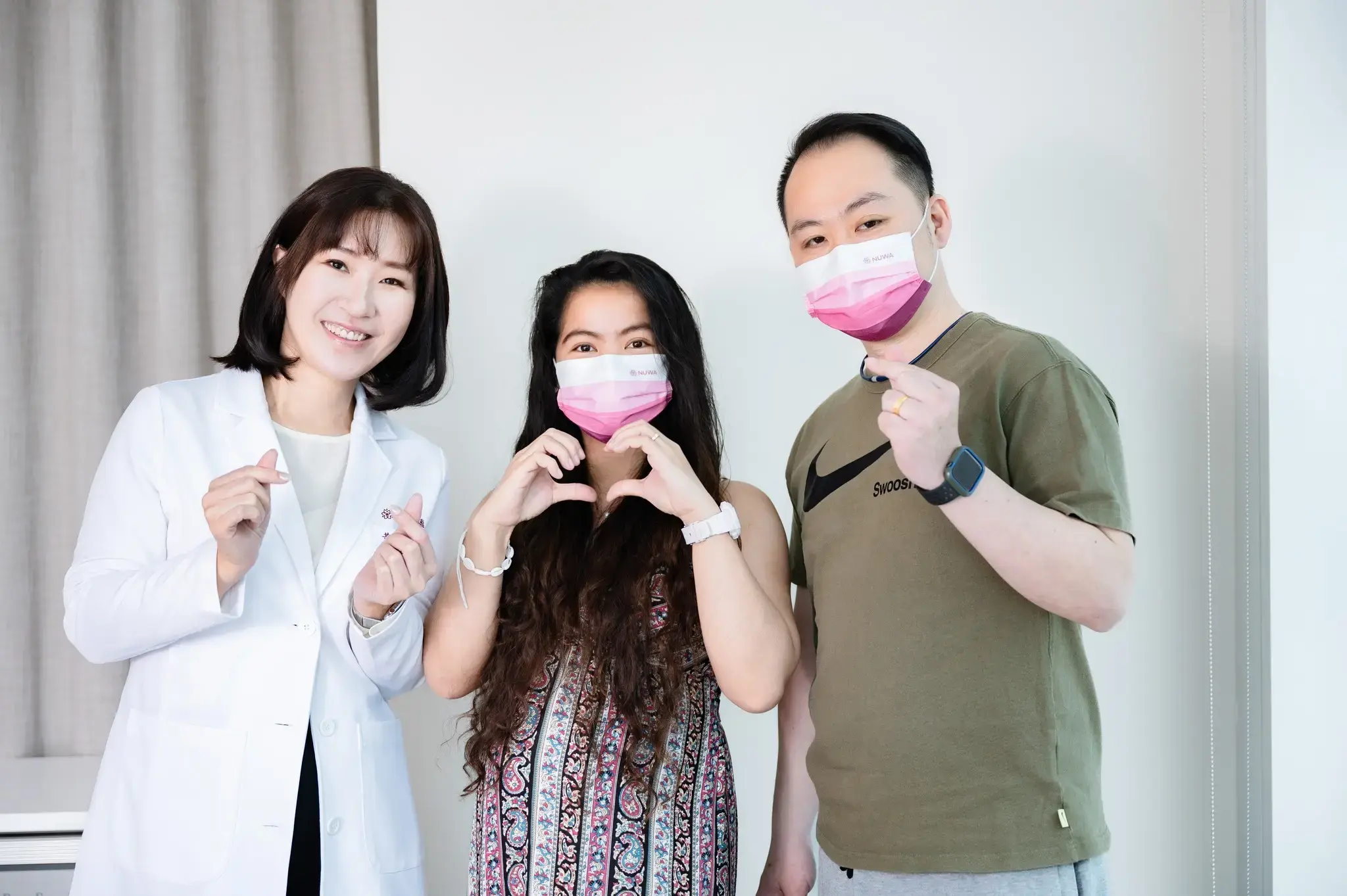 Filipino couple with PCOS posing with Dr. Pei-Chen Huang after successfully conceiving through IVF treatment at NUWA fertility Center.